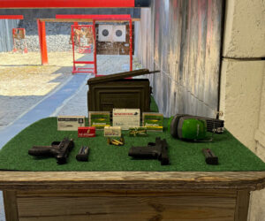 Shooting bench with hand guns, ammo, and noise cancelling headphones